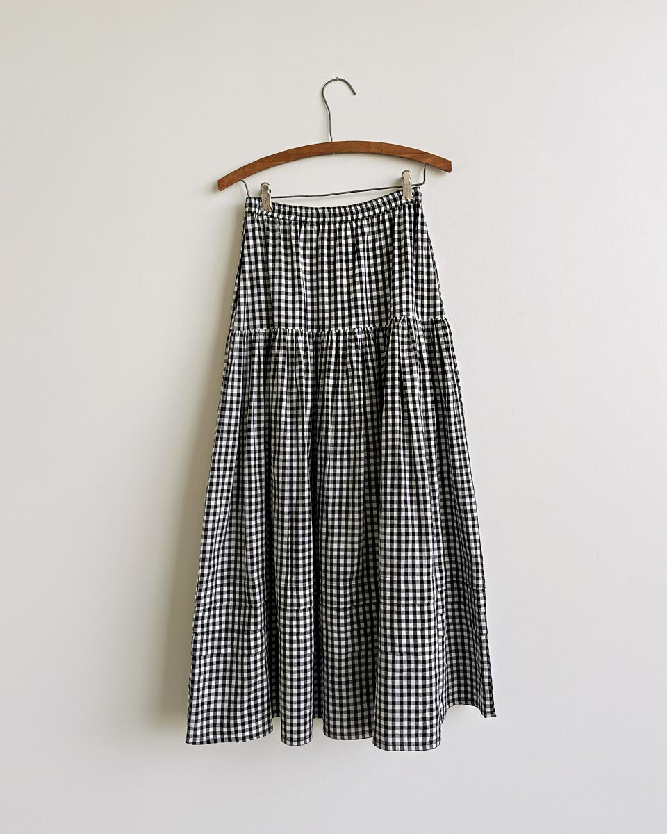 Gardenne Skirt in Prairie Noir — vintage-inspired cotton gingham midi skirt with drawstring waist and pleated hem.