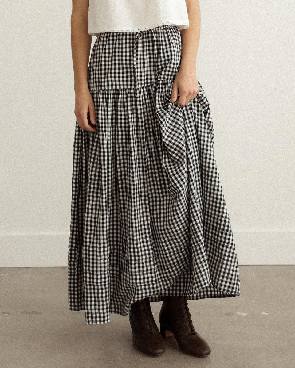 Gardenne Skirt in Prairie Noir — vintage-inspired cotton gingham midi skirt with drawstring waist and pleated hem.
