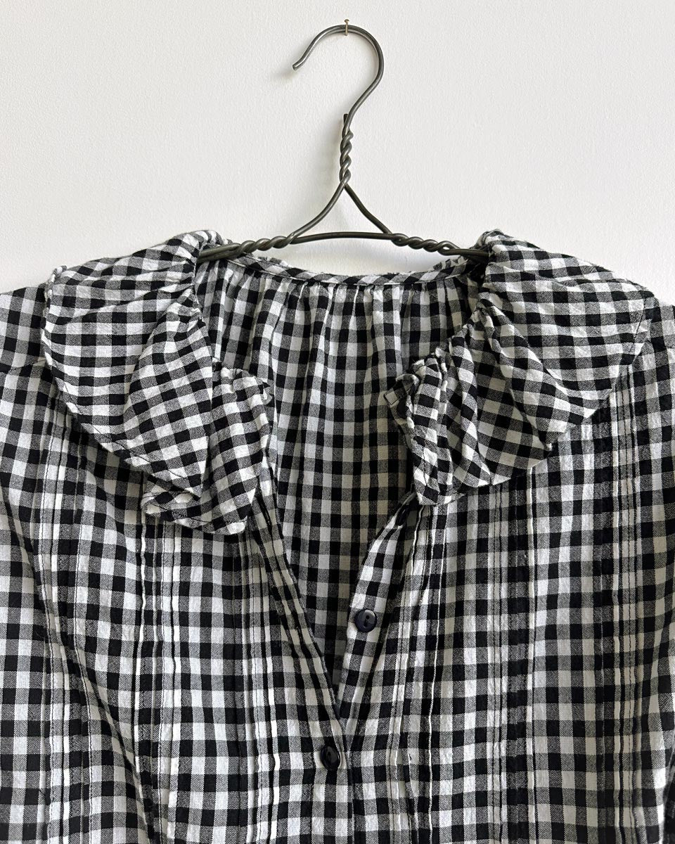 Nesaea Top in Prairie Noir — vintage-inspired black and white gingham blouse with ruffles and puff sleeves.